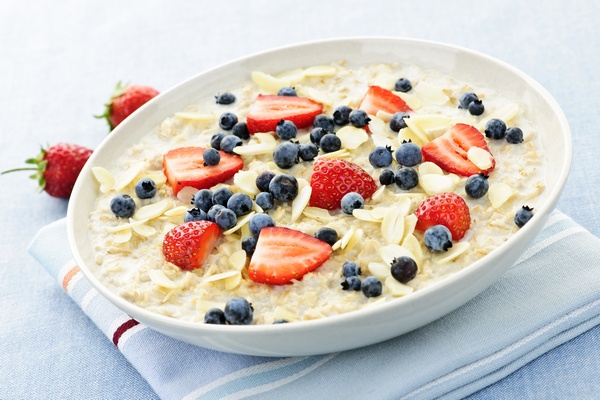 Bowl of hot oatmeal breakfast cereal with fresh berries menu sahur simpel